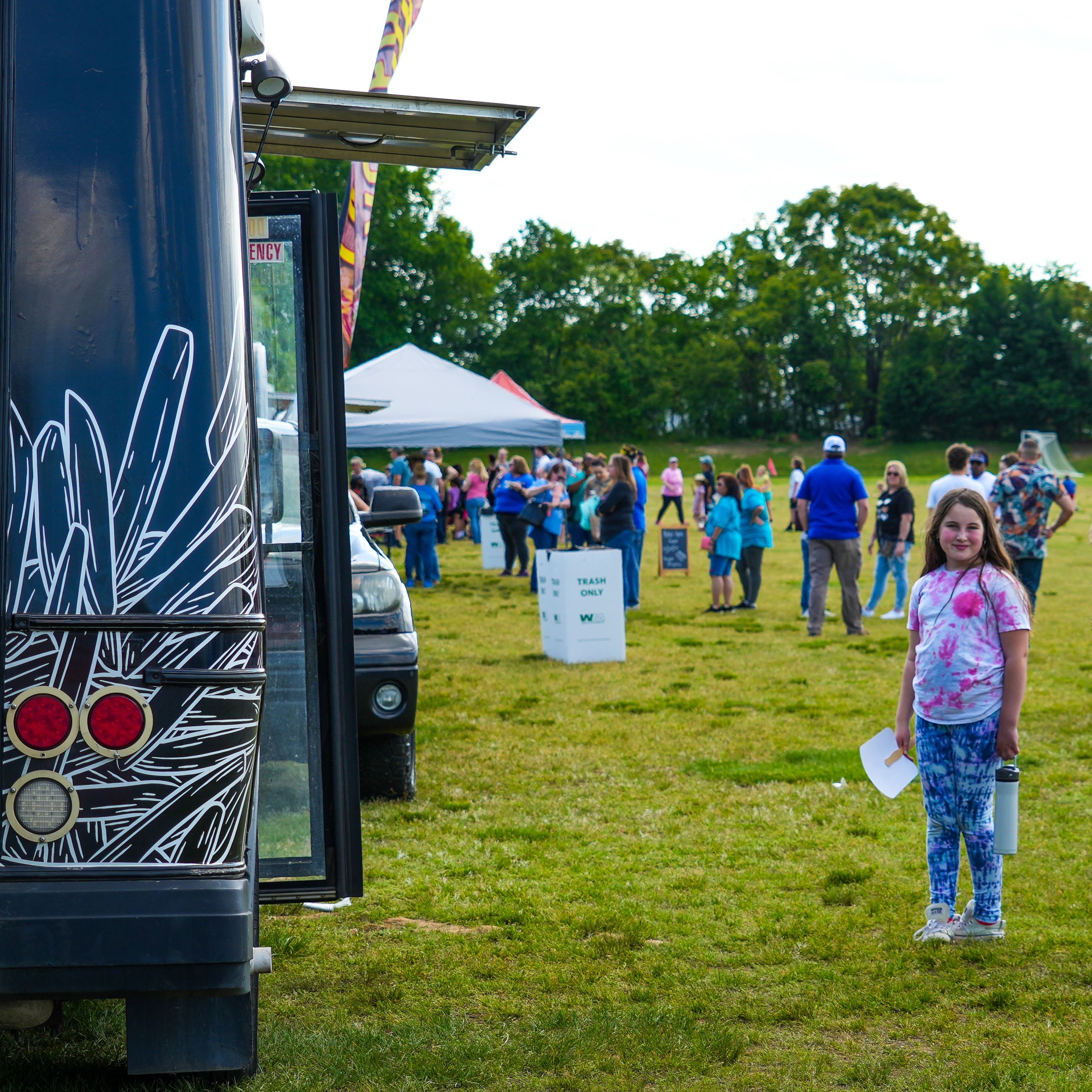 A kid standing in front of a food truck
