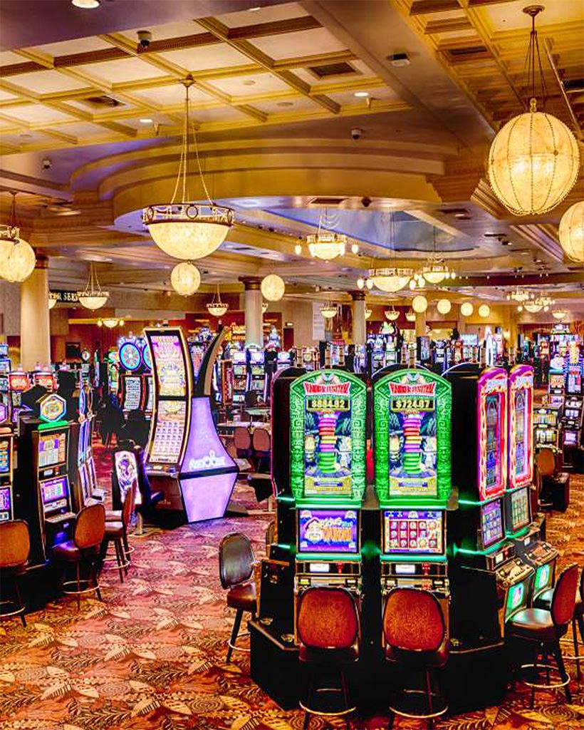 A casino with slot machines in the foreground.